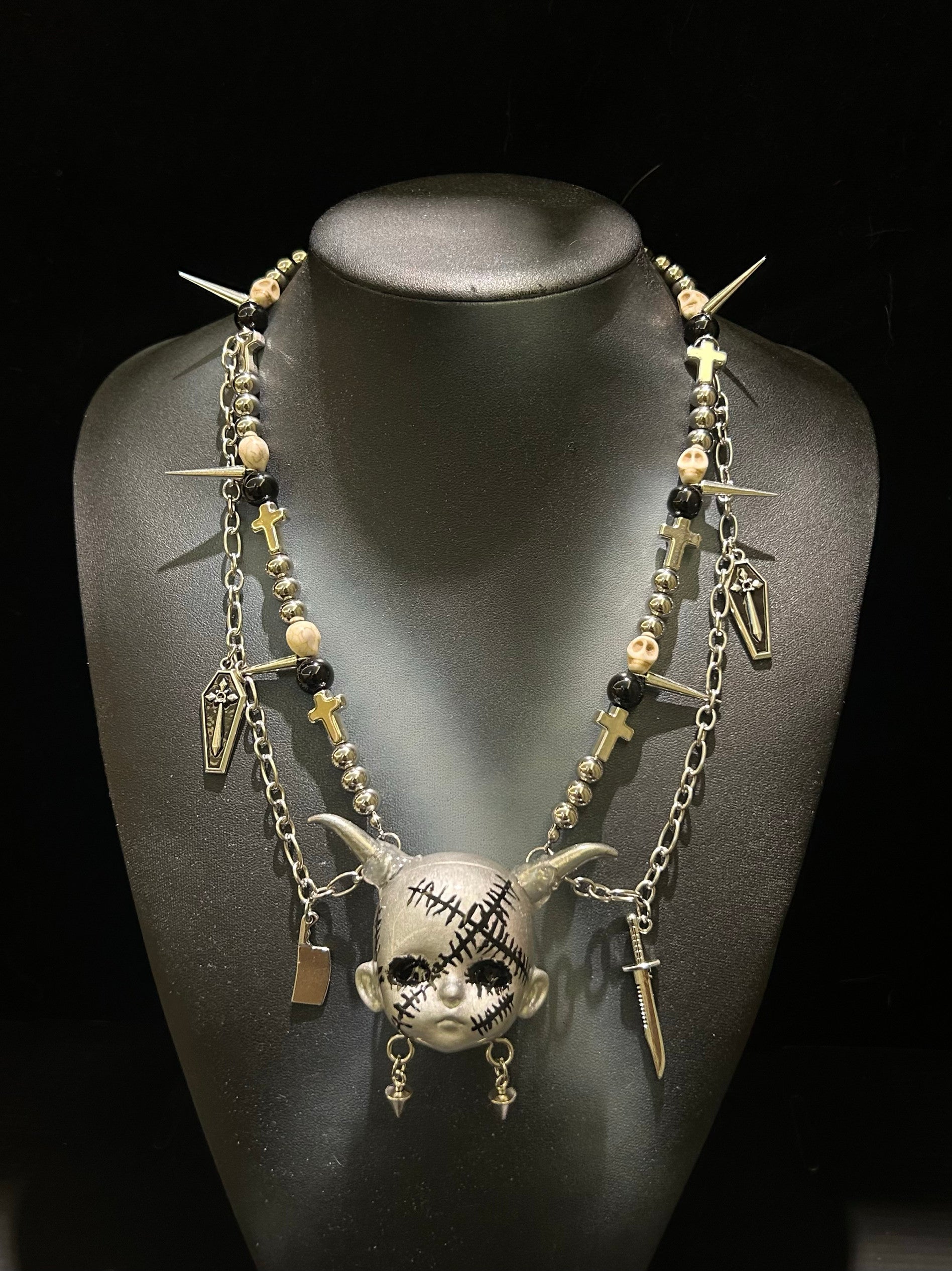 Silver Horned Stitched Doll Face Necklace with Cleaver, Knife & Coffin Charms