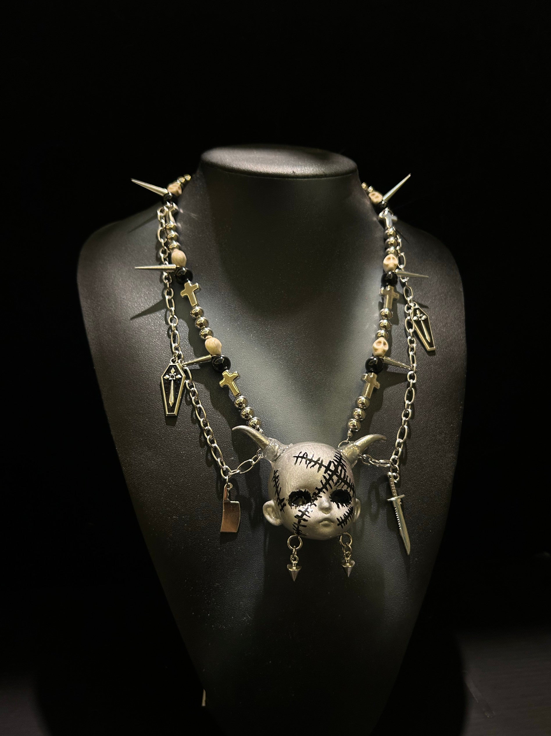 Silver Horned Stitched Doll Face Necklace with Cleaver, Knife & Coffin Charms